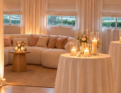 Curved ivory lounge sofa with blush pillows.