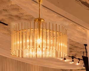Glass chandelier glowing against the textured ceiling.